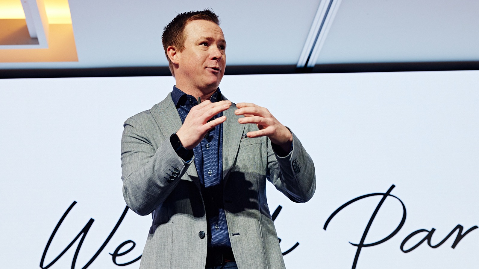 Curt Steinhorst speaking on stage at a conference.