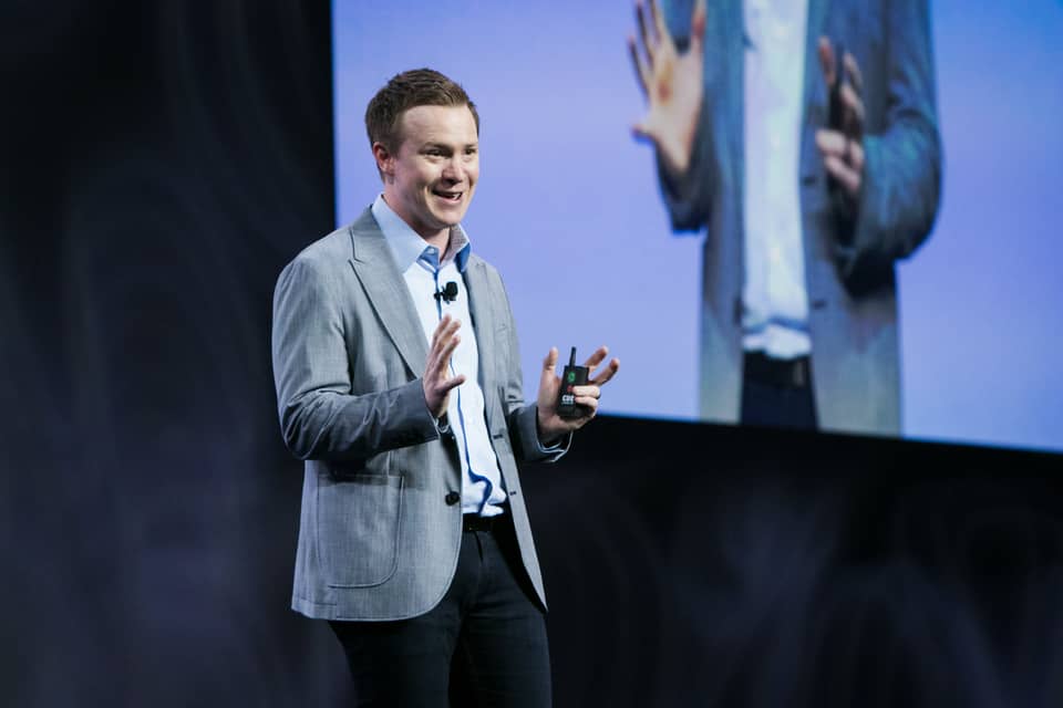 Curt Steinhorst mid-keynote on a conference stage
